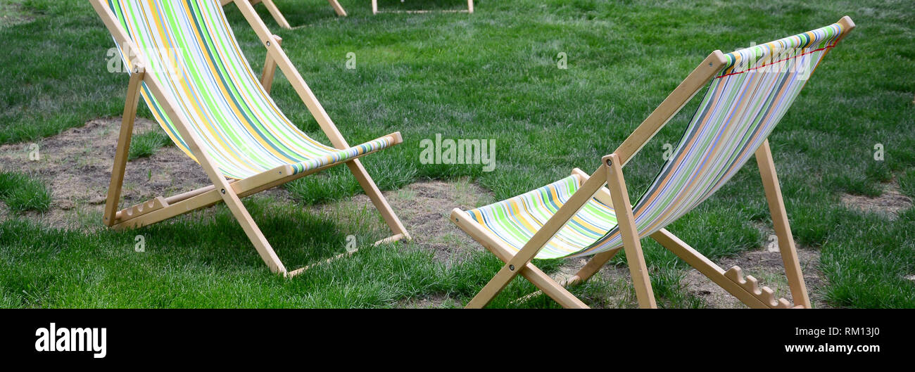 Chaise lounges on a lawn. Rest in the festival, on vacation. Garden