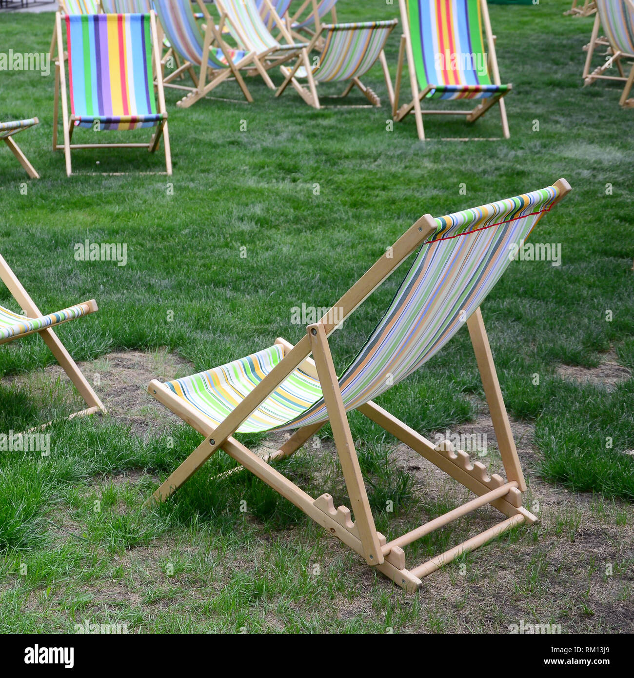 Chaise lounges on a lawn. Rest in the festival, on vacation. Garden