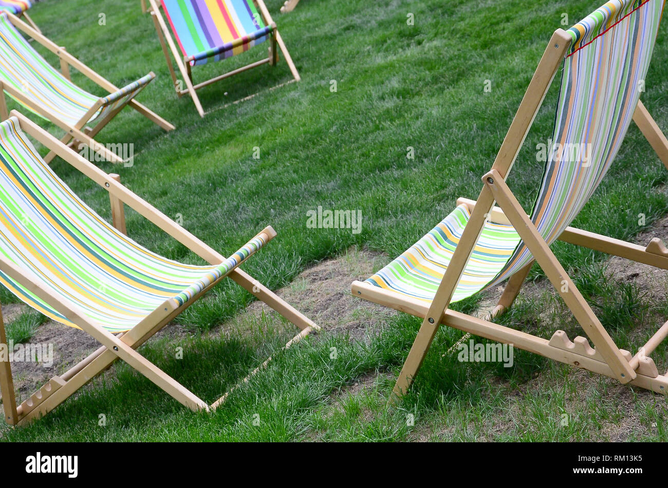 Chaise lounges on a lawn. Rest in the festival, on vacation. Garden