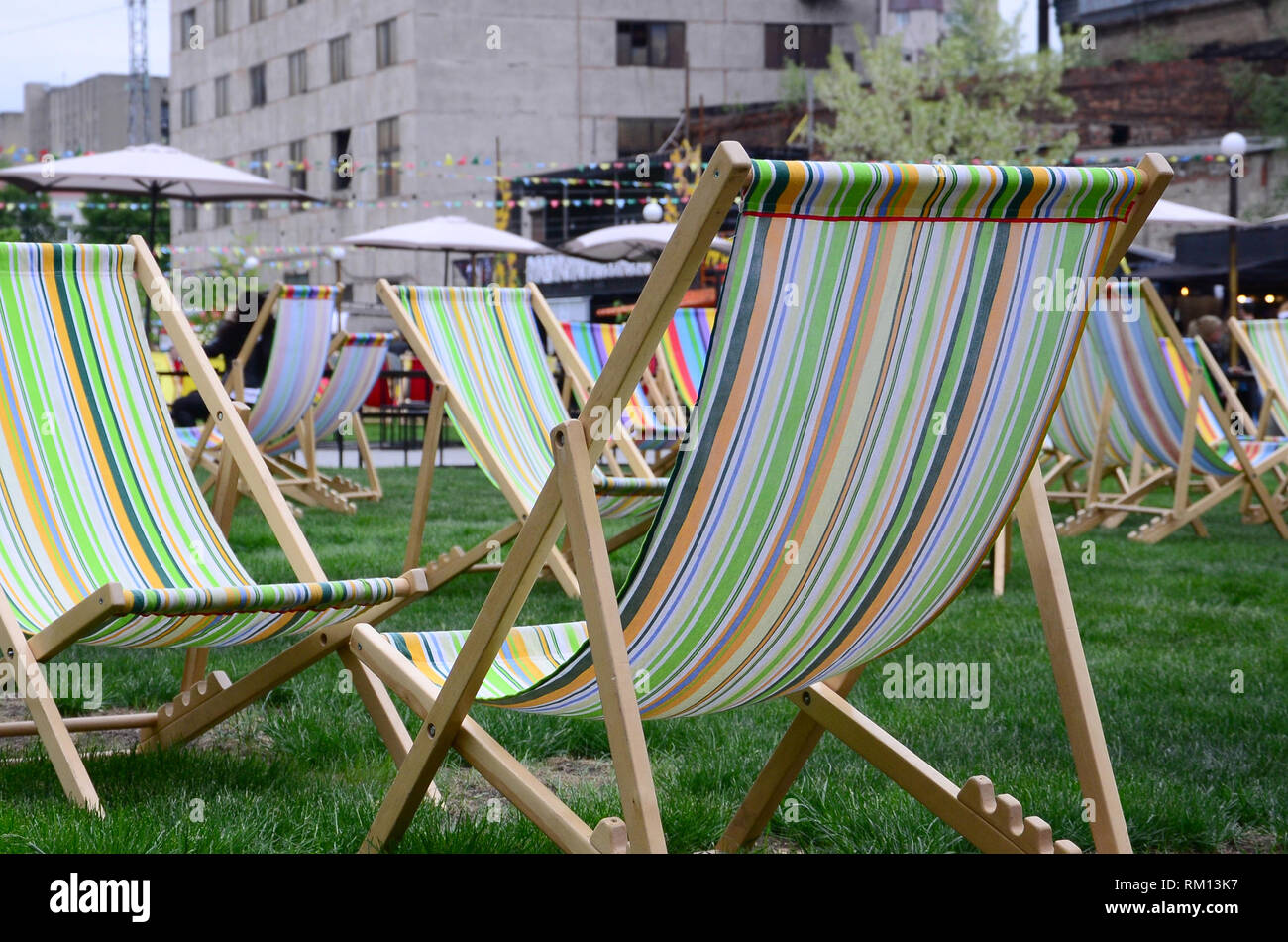 Chaise lounges on a lawn. Rest in the festival, on vacation. Garden
