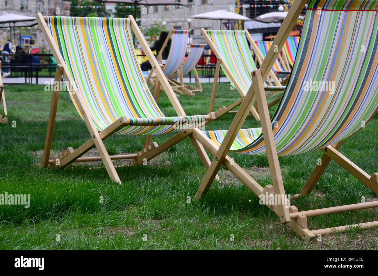 Chaise lounges on a lawn. Rest in the festival, on vacation. Garden