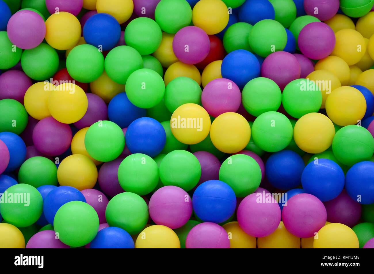 Colored plastic balls in pool of game room. Swimming pool for fun and