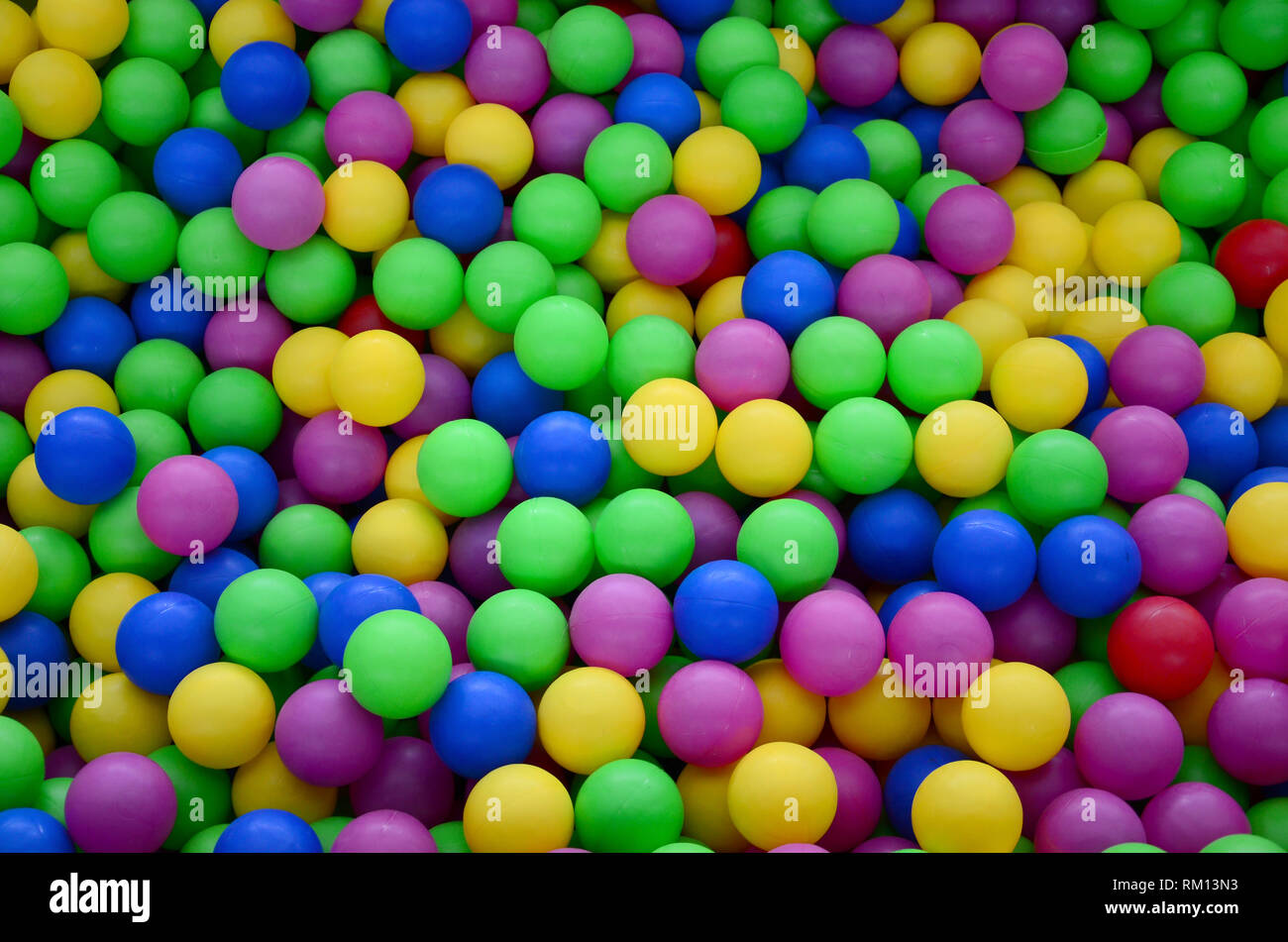 Colored plastic balls in pool of game room. Swimming pool for fun and