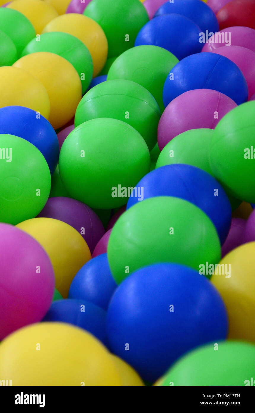 Colored plastic balls in pool of game room. Swimming pool for fun and