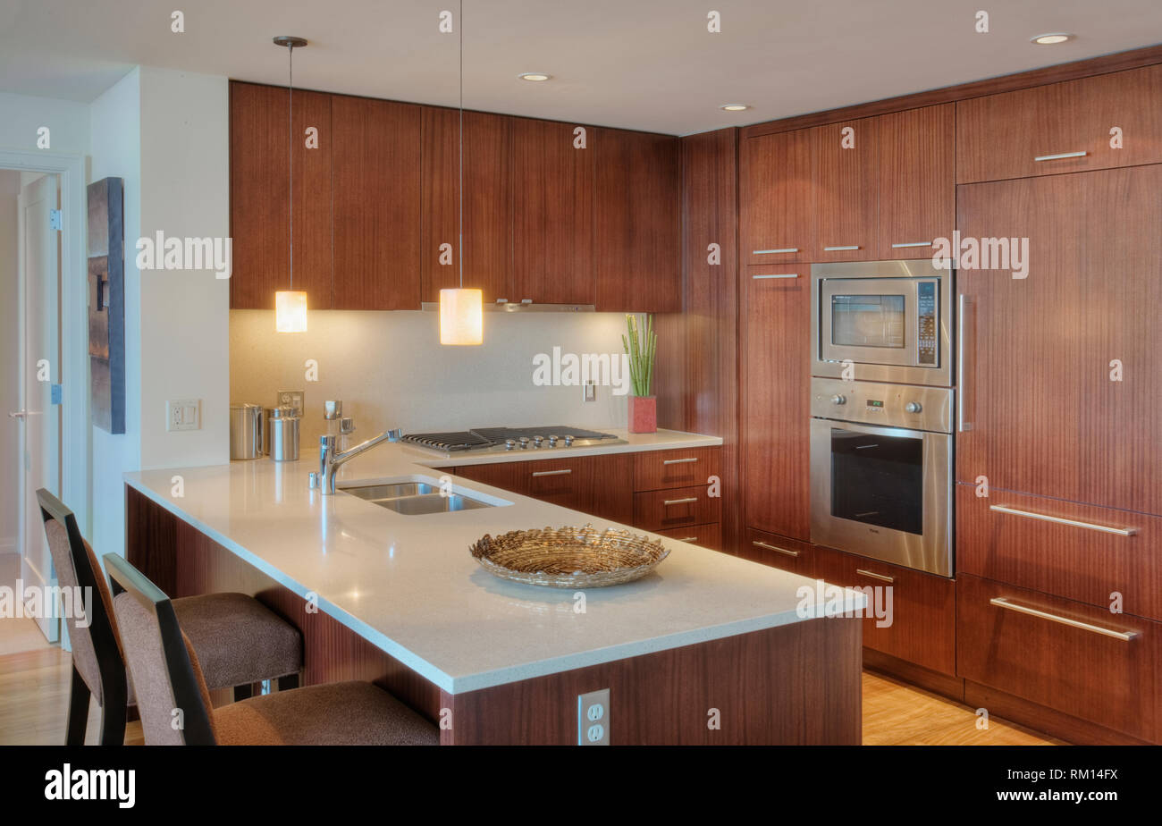 Wood cupboards in modern kitchen Stock Photo - Alamy