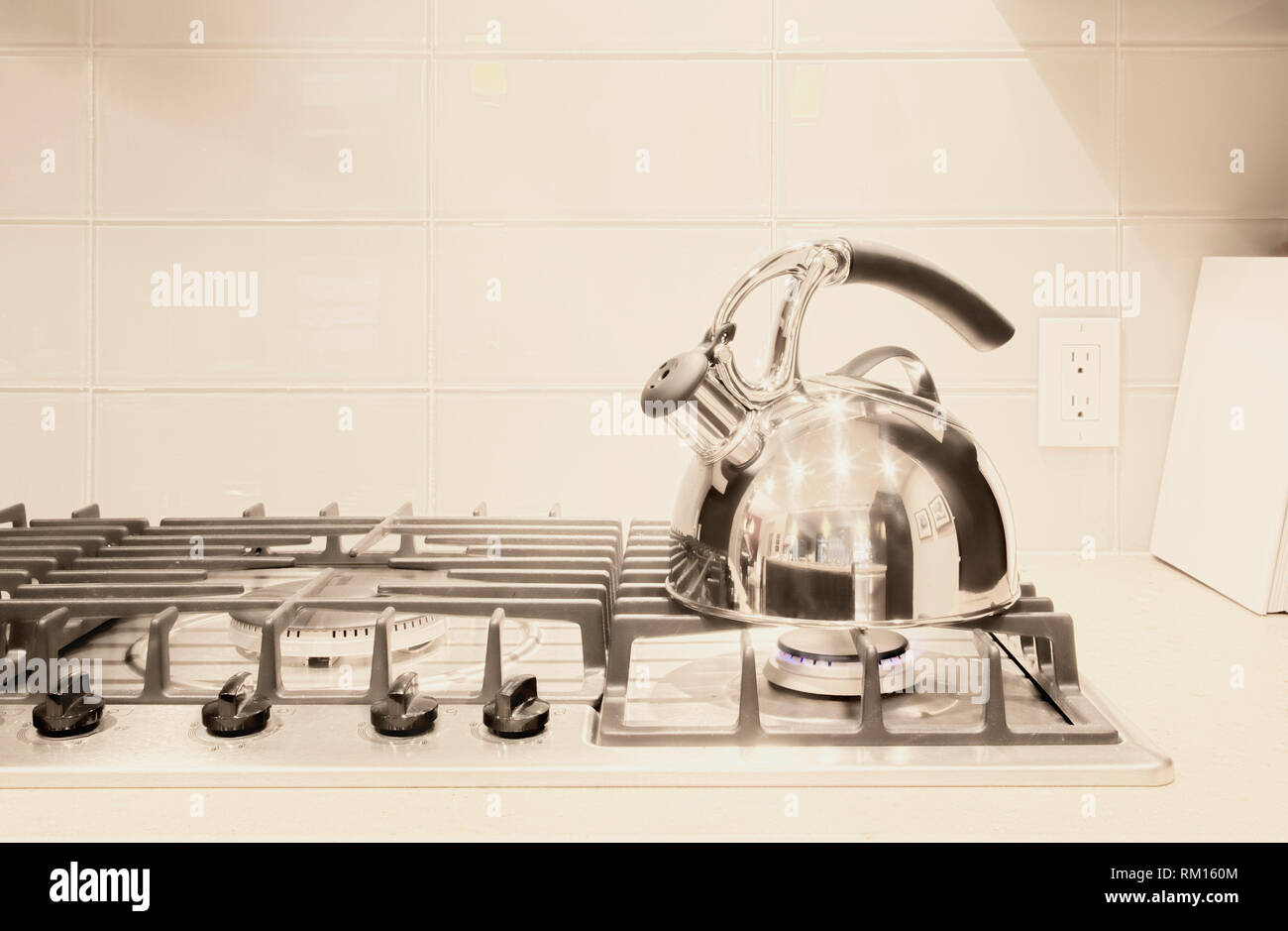 Stainless steel tea kettle on stove Stock Photo Alamy