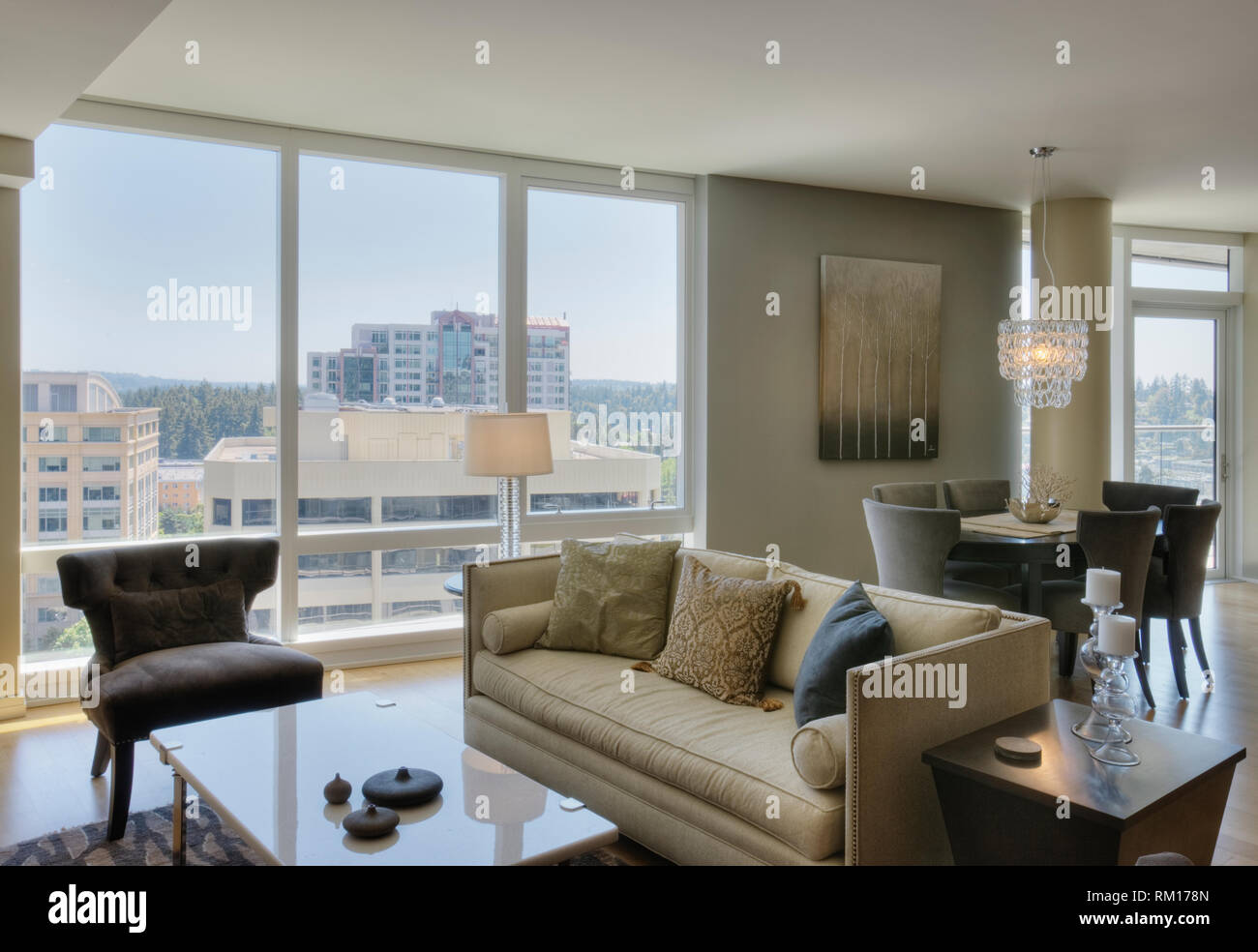 Picture of Living room and dining room in luxury highrise apartment Stock Photo ...