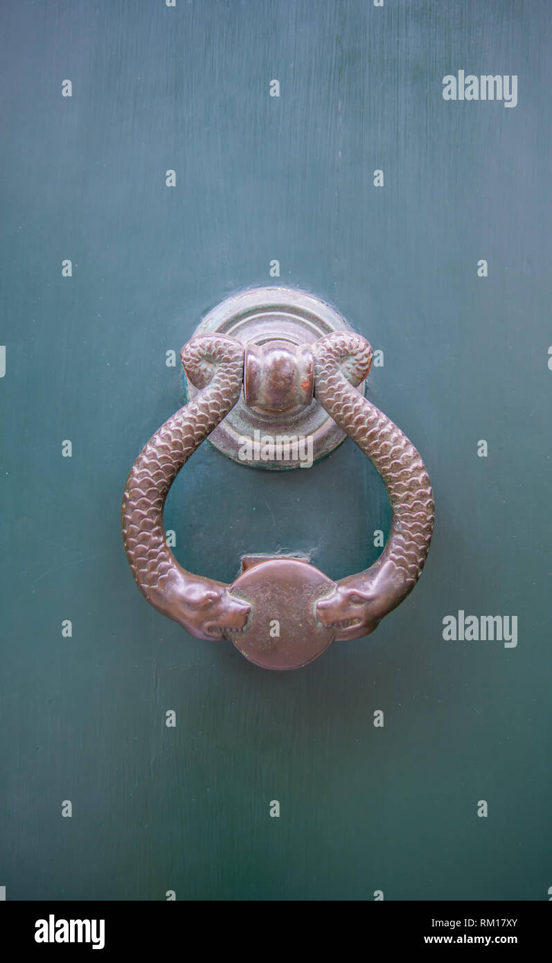 Architectural details Antique bronze door knocker with snakes Stock