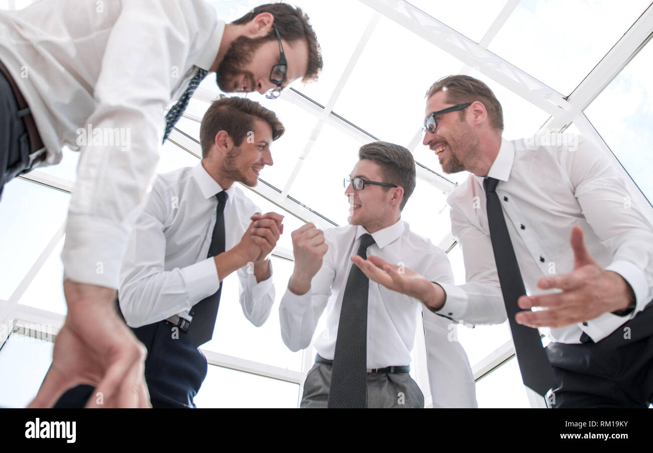 bottom view.happy business team standing near the negotiating table Stock Photo