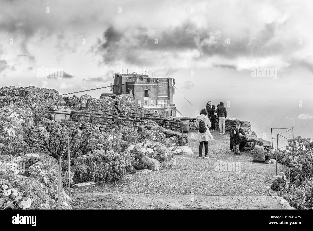 CAPE TOWN, SOUTH AFRICA, AUGUST 17, 2018: A walking trail on the top of Table mountain in Cape Town. The upper cable station and tourists are visible. Stock Photo