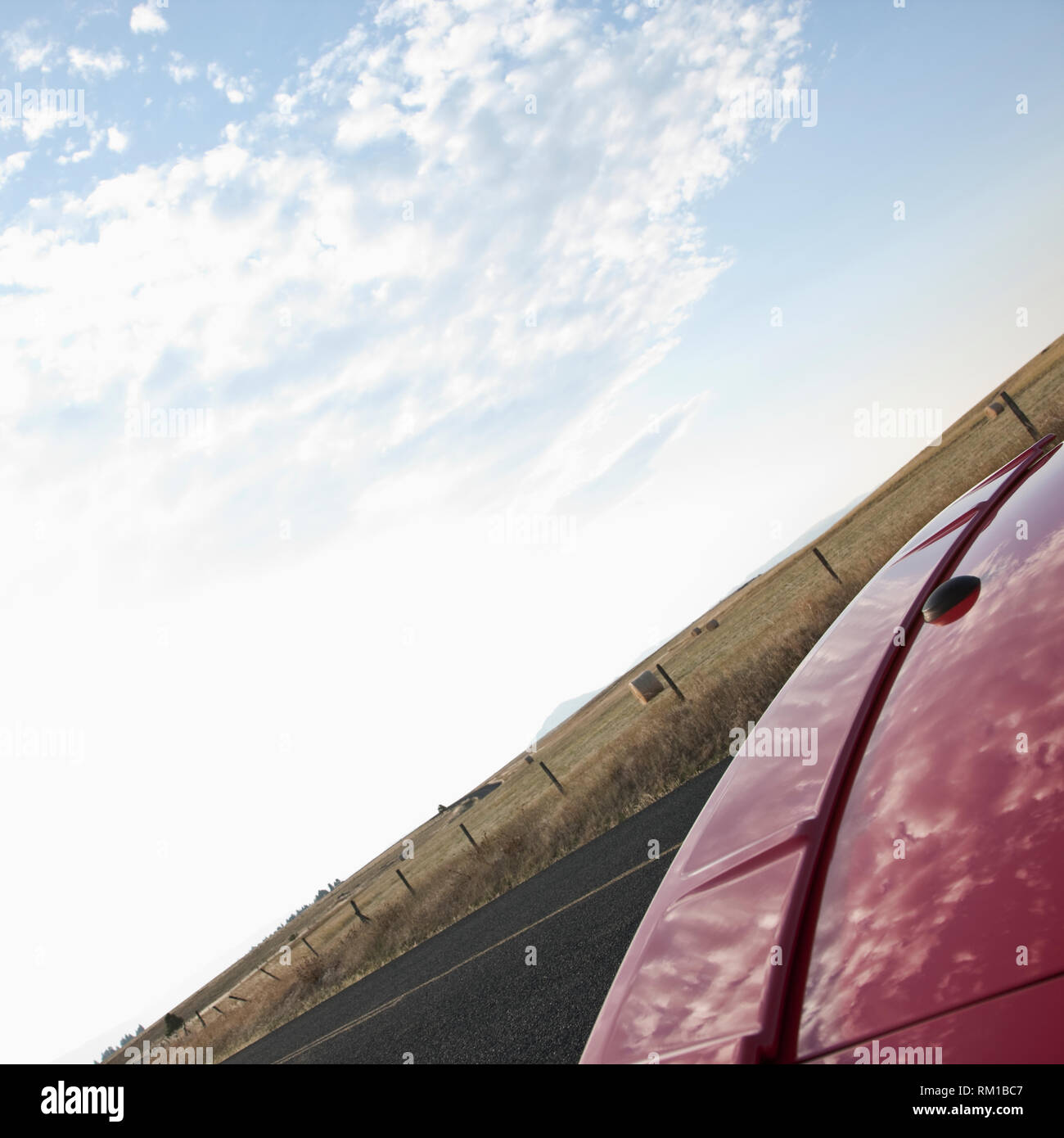 Trunk of Red Car Reflecting Clouds Stock Photo