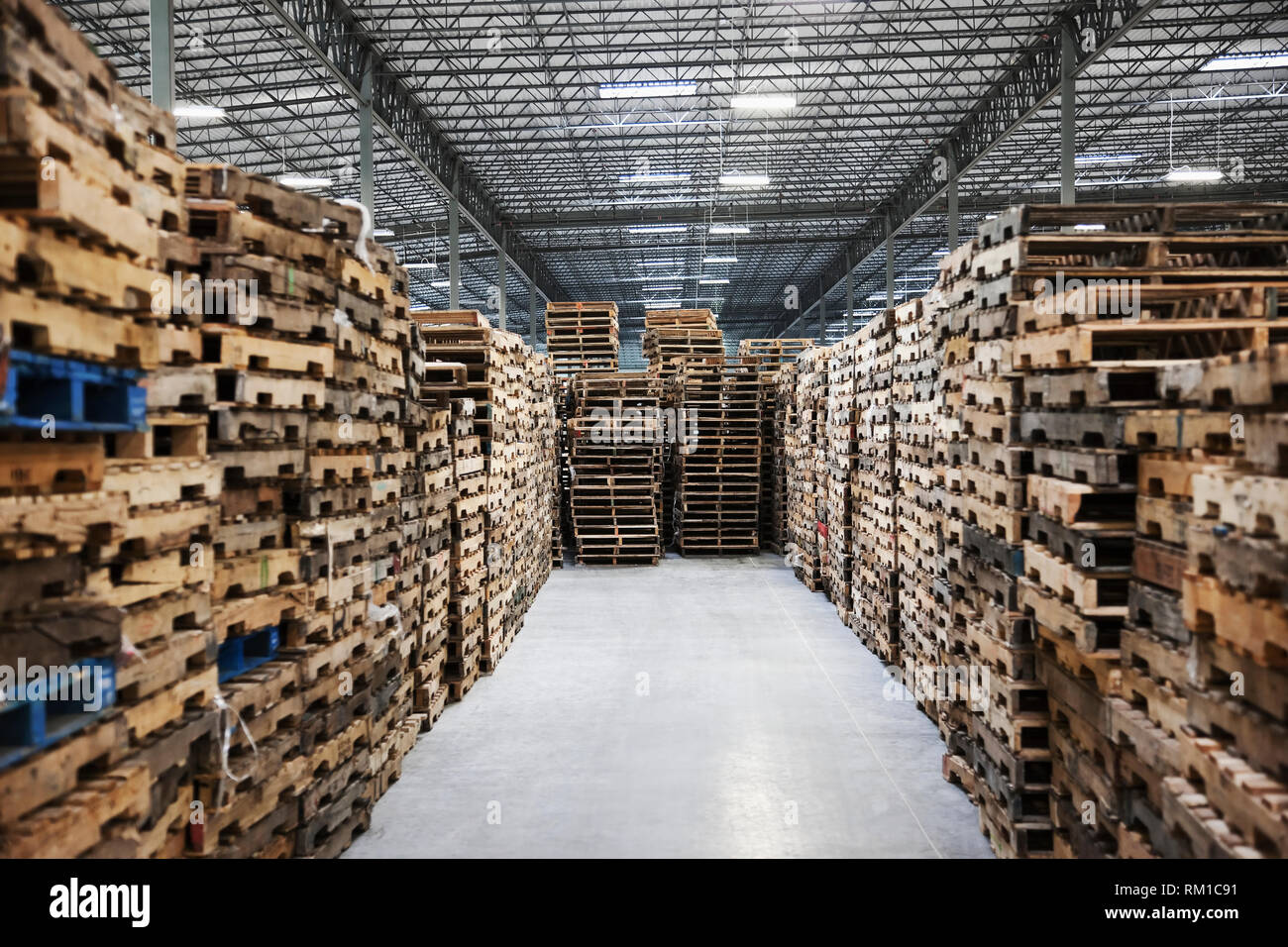 Stacked pallets in warehouse Stock Photo - Alamy
