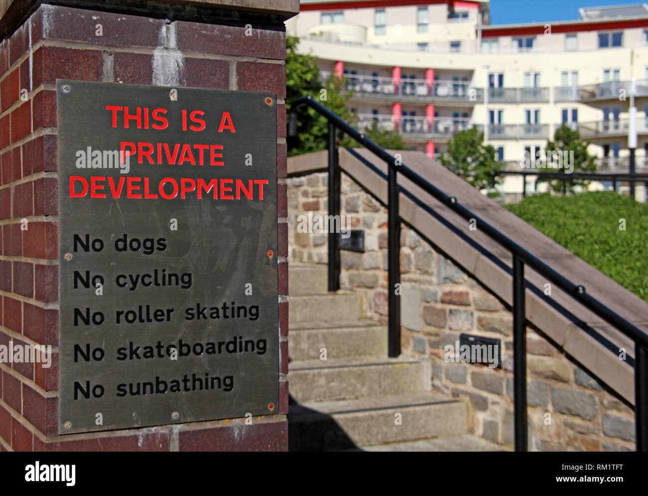 Sign - This is a private development, No Dogs, No Cycling, No rolling skating, No Skateboarding, No sunbathing, Bristol Harbour, Harbourside Stock Photo