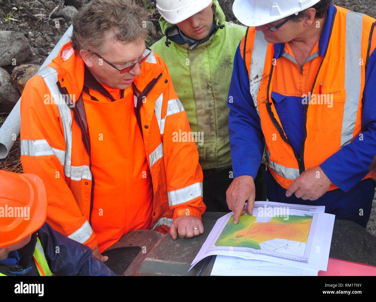 Geologists discuss the oil-bearing formation being explored in a seismic reflective survey on the West Coast of New Zealand Stock Photo