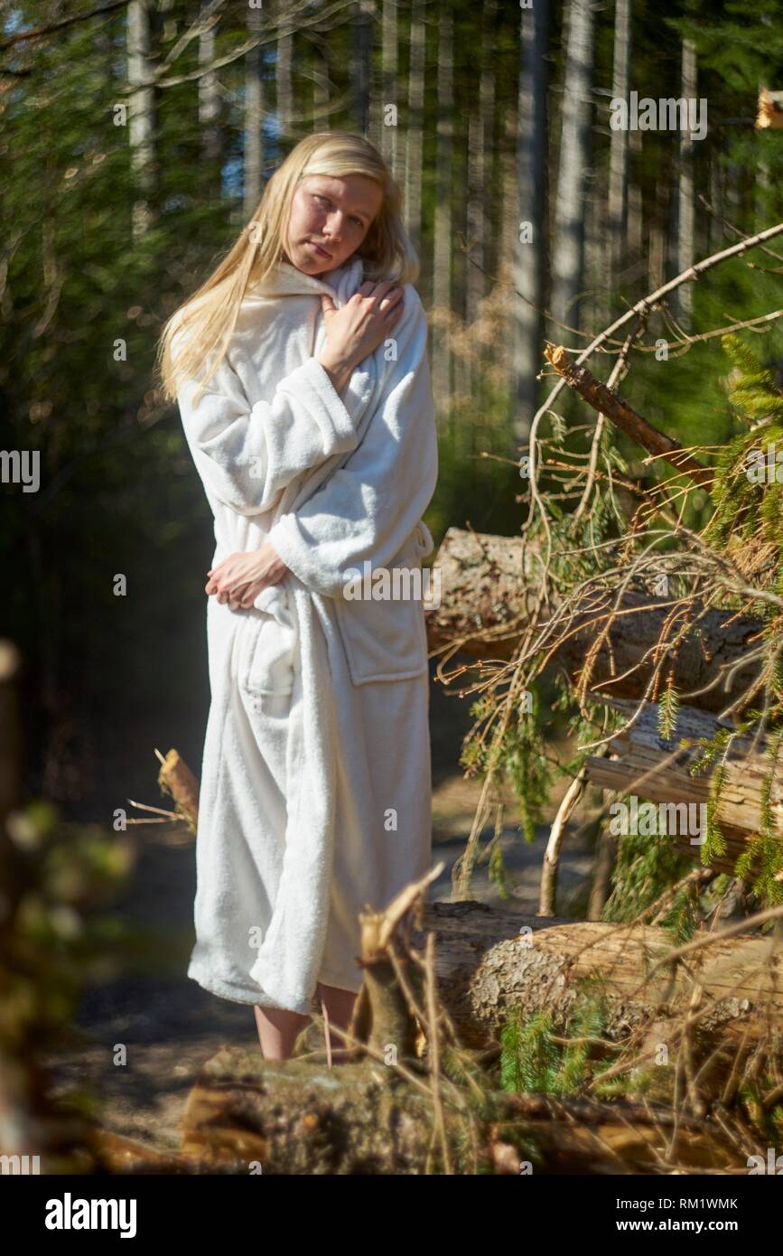 Portrait of woman in nature wearing a white bathrobe. Waakirchen