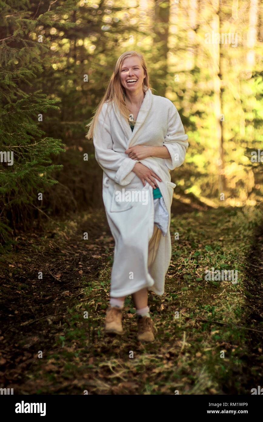 Portrait of woman in nature wearing a white bathrobe. Waakirchen, Bavaria, Germany Stock Photo
