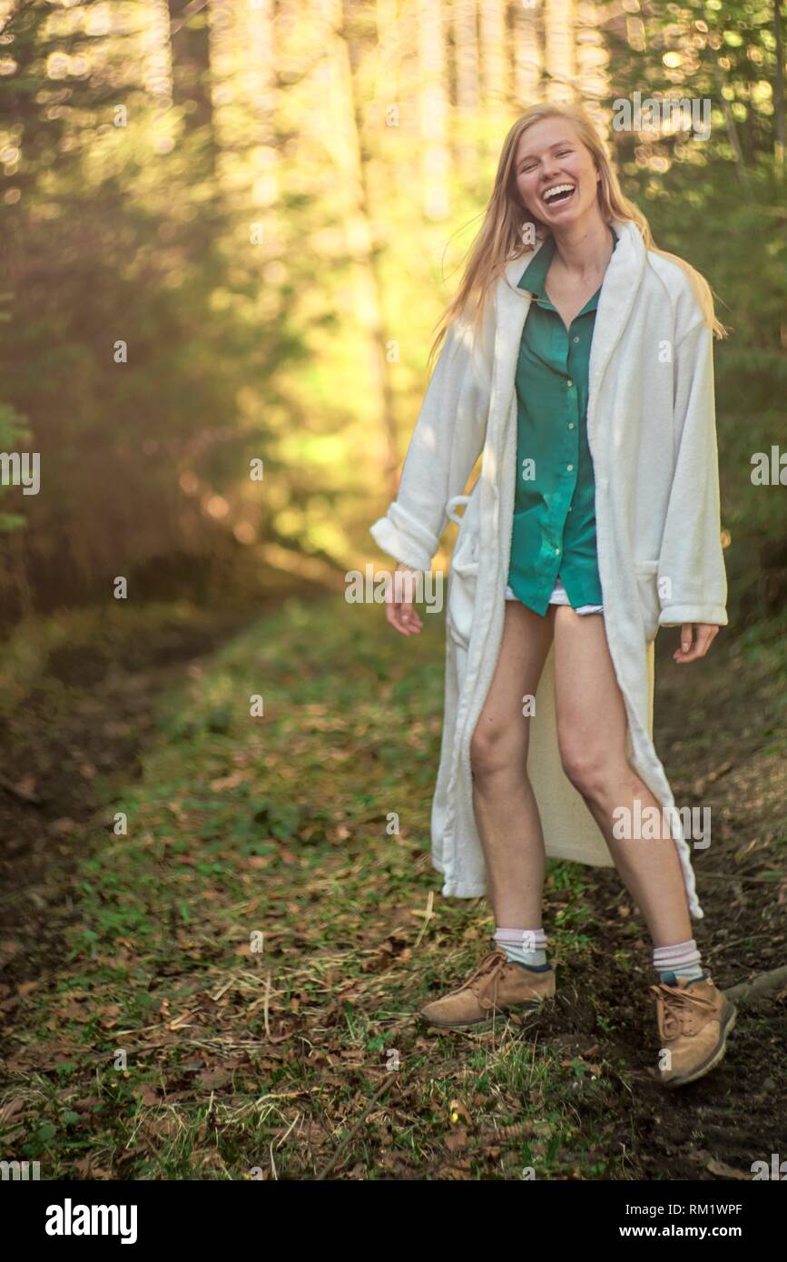 Portrait of woman in nature wearing a white bathrobe. Waakirchen, Bavaria, Germany Stock Photo