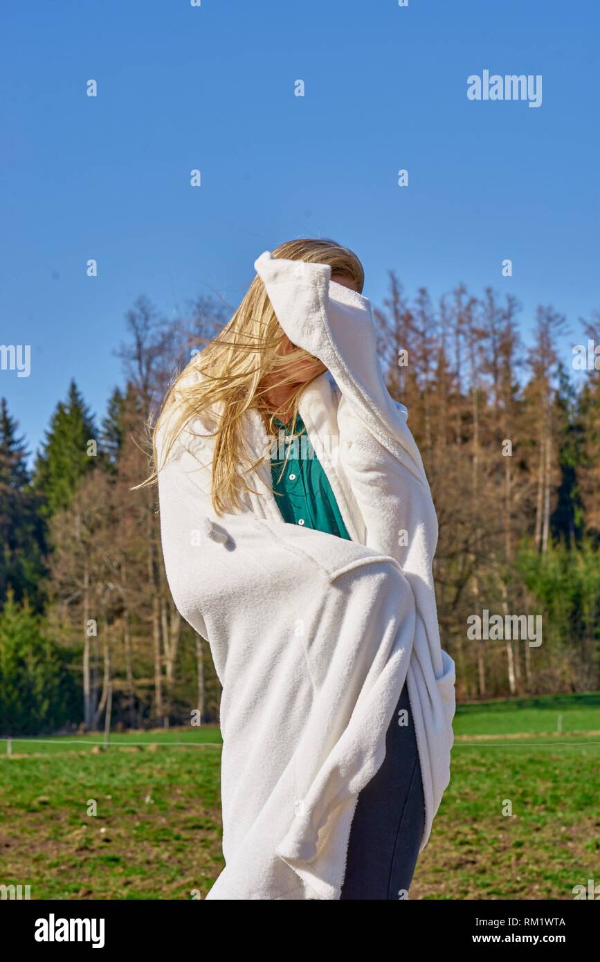 Portrait of woman in nature wearing a white bathrobe. Waakirchen