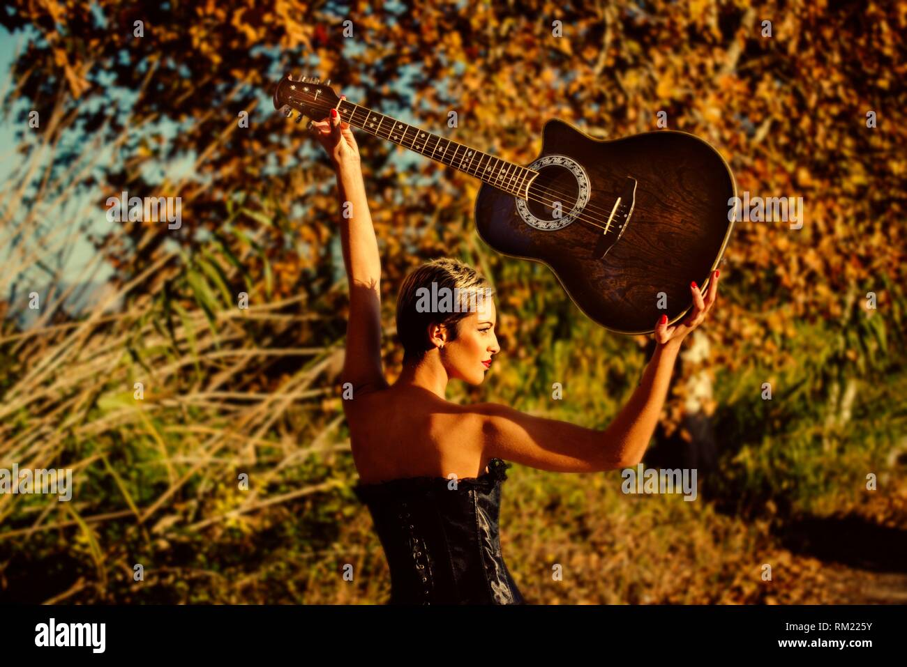 Victoria of Rock and Roll, a woman from Rokera holds her guitar up Stock Photo