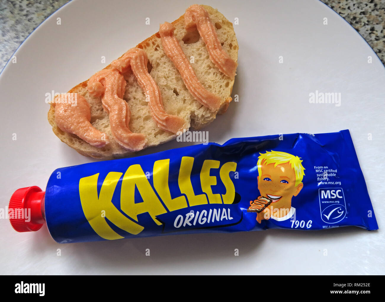 A blue tube of Kalles Original,  salted cod roe (gadus morhua), sugar, canola oil and spices, squirted on to fresh bread, Swedish IKEA Food Stock Photo