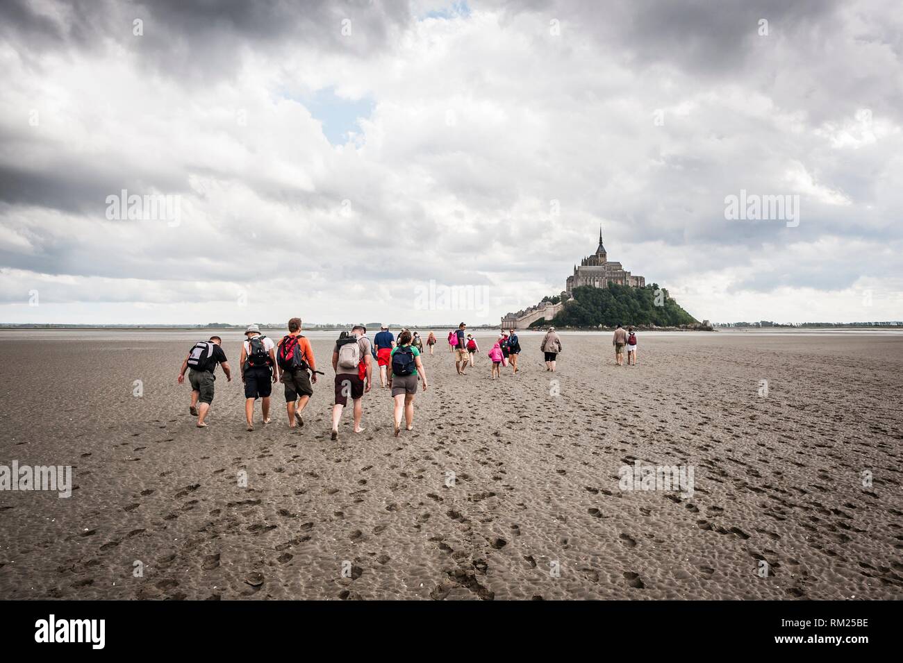 Guided tour to cross Mont Saint Michel bay during low tide (department of Manche, region of Normandie, France). Stock Photo