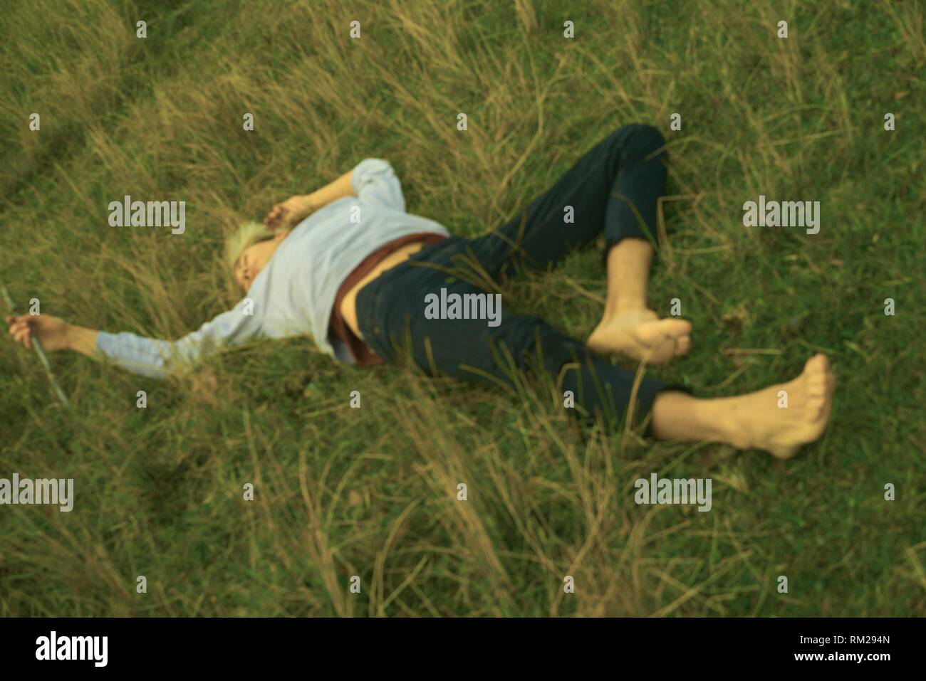 lying in meadow, nature, bonding, back to nature, lost, resting, exchausted, exhaustion, relaxing, escaping daily life, escaping Stock Photo - Alamy