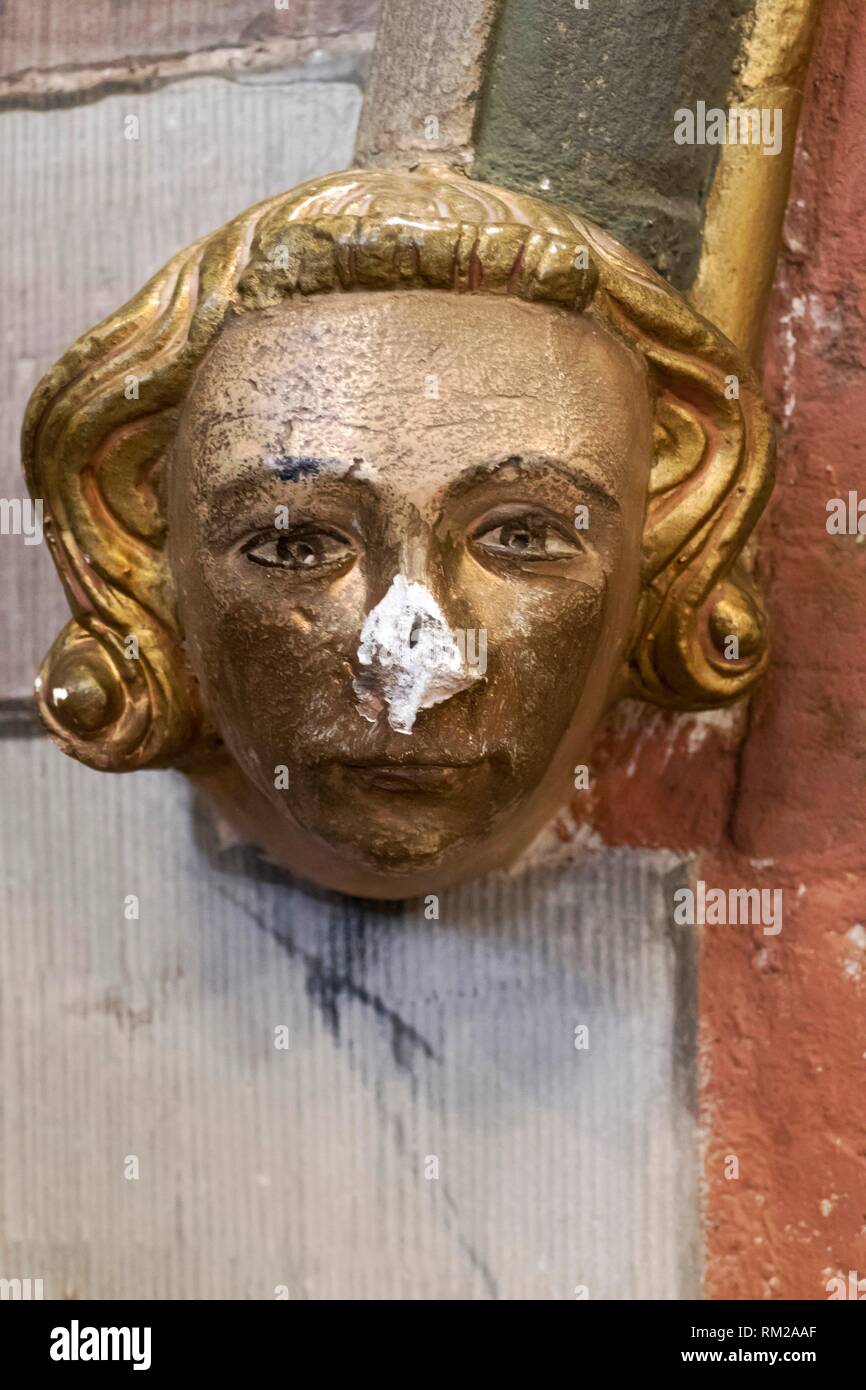 Carved and painted architectural head boss of a young Medieval nobleman with golden hair and a broken nose, Hereford Cathedral, Hereford, England. Stock Photo