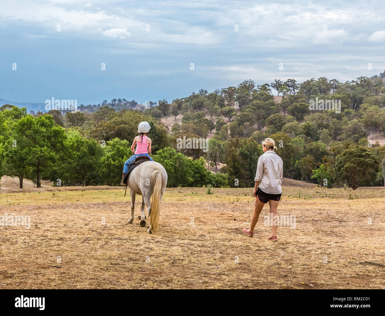Young child learning to ride iahorse n the Upper Hunter Valley, NSW, Australia. Stock Photo