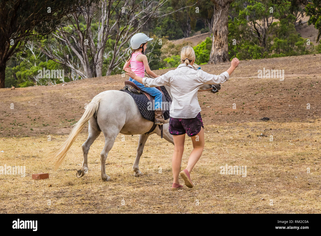 Young child learning to ride iahorse n the Upper Hunter Valley, NSW, Australia. Stock Photo