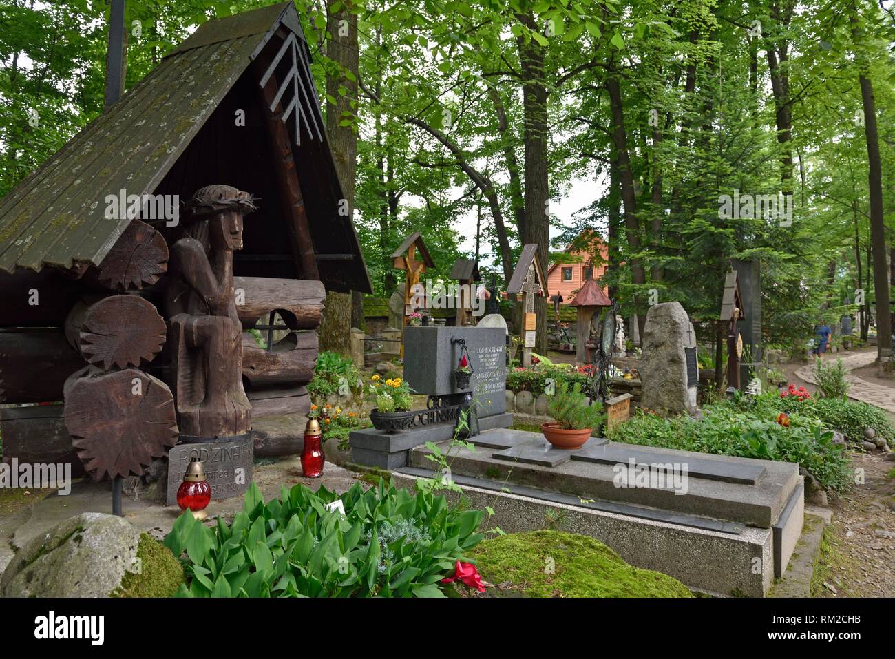 representation of ´´Worried´´ or ´´Distressed´´ Christ, related to the Polish folk culture, on wooden funerary stela in the old cemetery of Zakopane, Stock Photo