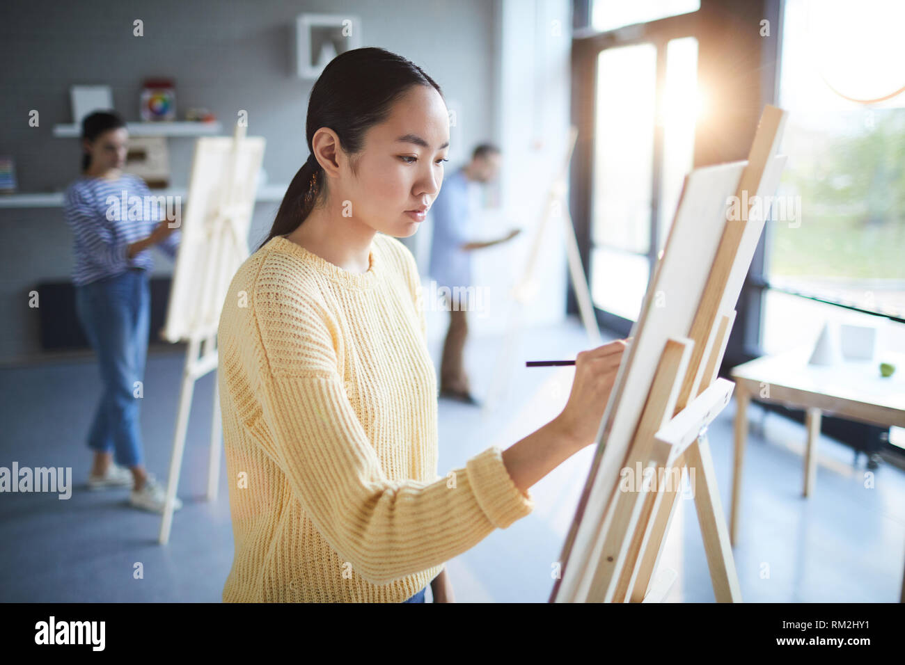 Girl by easel Stock Photo Alamy