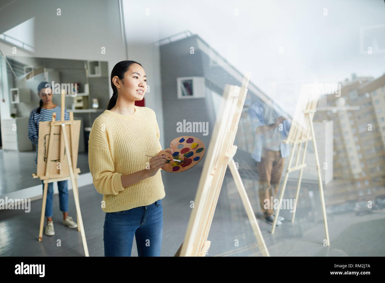 Girl in front of easel Stock Photo - Alamy