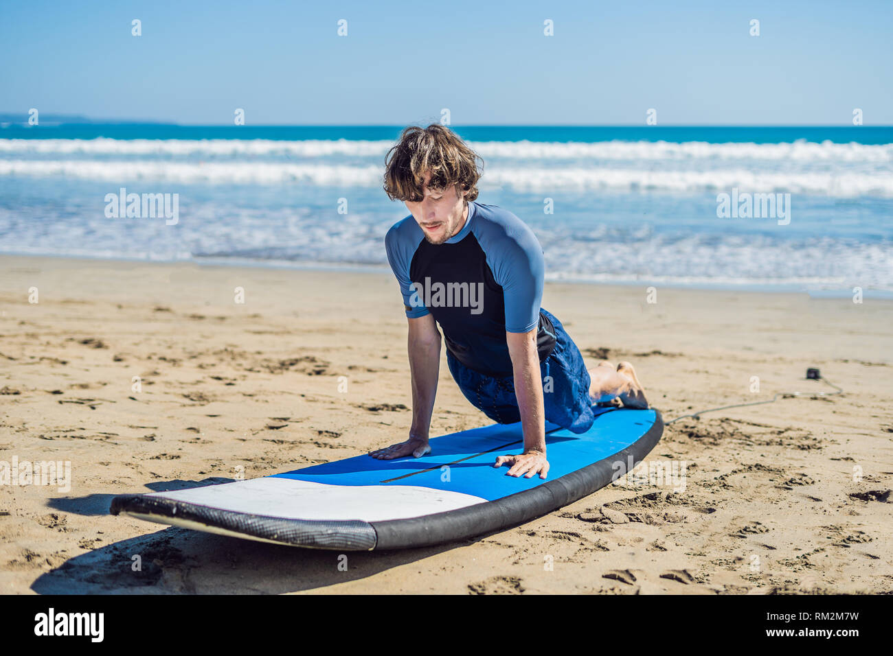 Young Man Surfer Training Before Go To Lineup On A Sand Beach Learning To Surf Vacation Concept Summer Holidays Tourism Sport Stock Photo Alamy