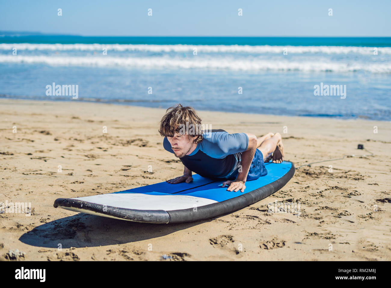 Young Man Surfer Training Before Go To Lineup On A Sand Beach Learning To Surf Vacation Concept Summer Holidays Tourism Sport Stock Photo Alamy