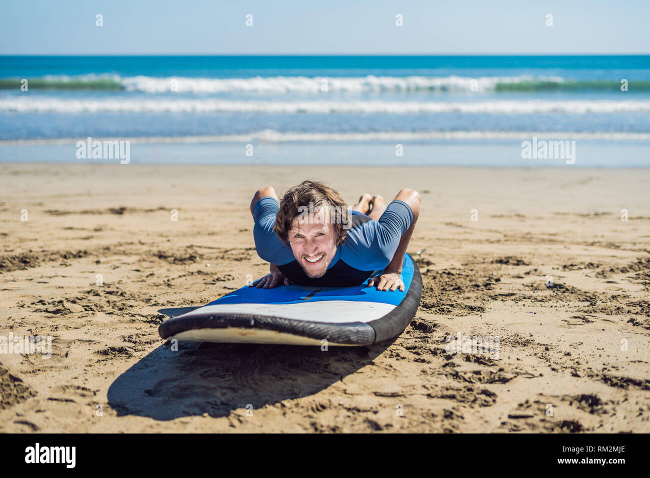 Young Man Surfer Training Before Go To Lineup On A Sand Beach Learning To Surf Vacation Concept Summer Holidays Tourism Sport Stock Photo Alamy