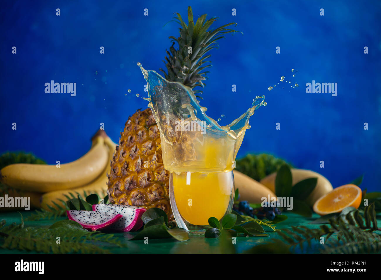 Fresh juice dynamic splash. Tropical fruits, bananas, pineapple, and dragon fruit. Exotic drink action photography with copy space Stock Photo