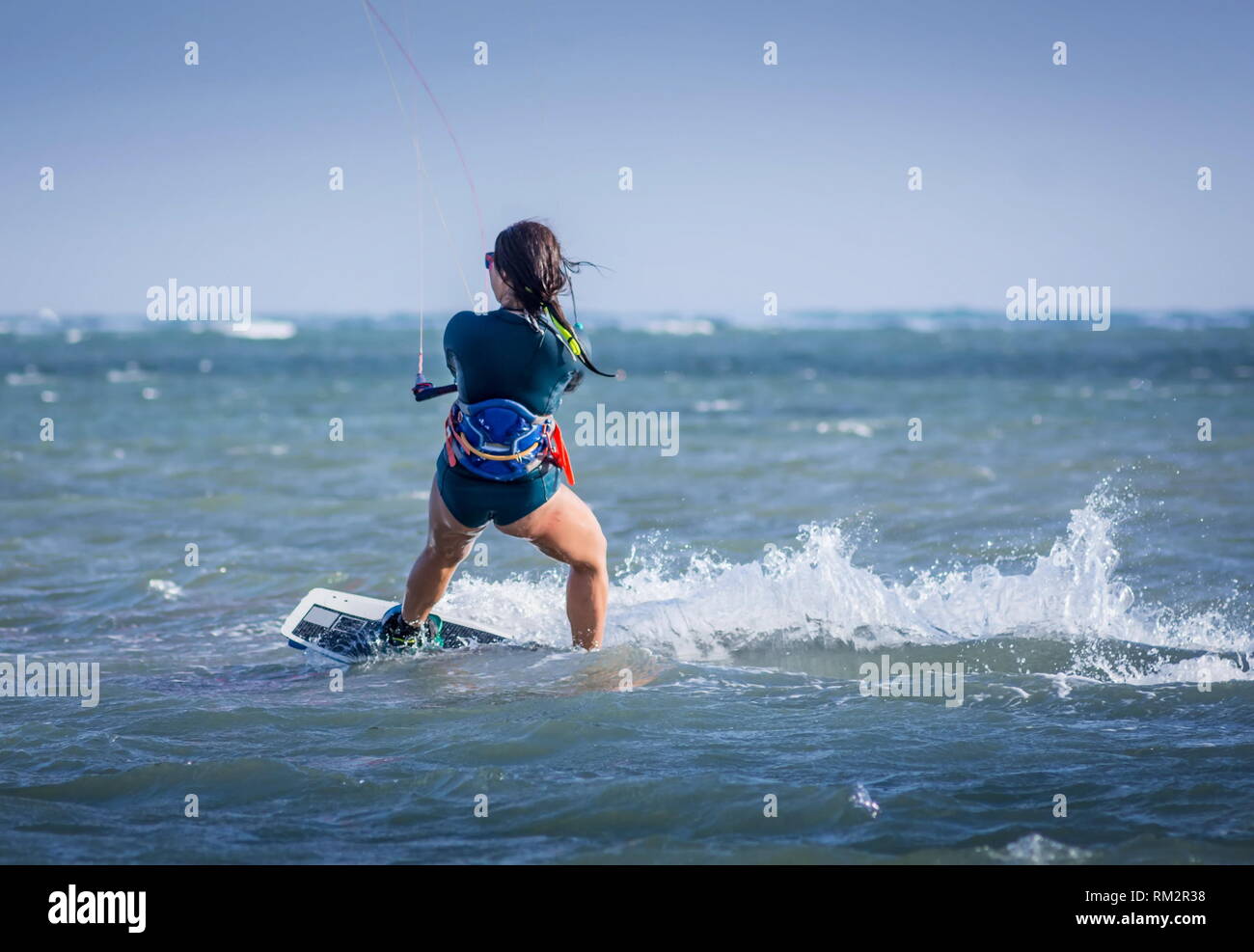 kiteboarder kitesurfer woman athlete performing kitesurfing