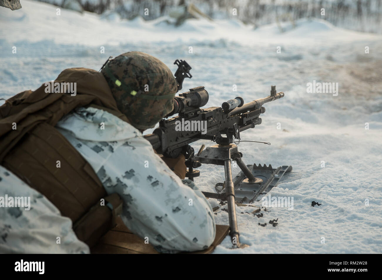 A U.S. Marine with Marine Rotational Force-Europe 19.1, Marine Forces Europe and Africa, fires a M240B machine gun in Setermoen, Norway, Feb. 8, 2019. This training increased MRF-E Marines’ proficiency at cold-weather and mountain-warfare tactical operations in cold-weather environments. (U.S. Marine Corps photo by Cpl. Nghia Tran) Stock Photo