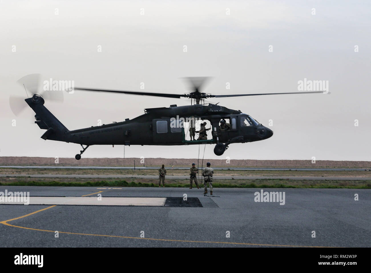 U.S. Army Soldiers hover in a UH-60 Black Hawk helicopter during fast ...