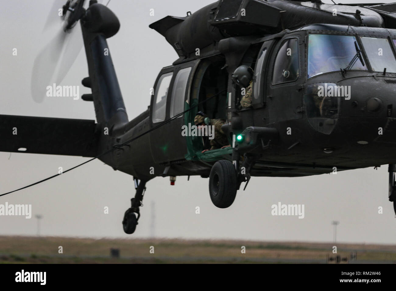 A U.S. Army Soldier from a UH-60 Black Hawk helicopter during fast rope ...