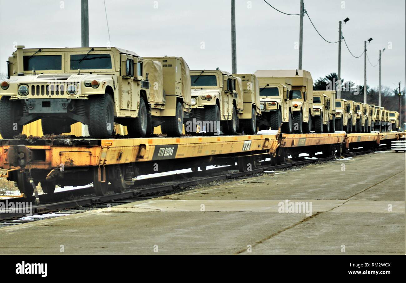 Military vehicles and equipment with the 389th Engineer Battalion is loaded on railcars Feb. 5, 2019, at the rail yard at Fort McCoy, Wis. The movement is for the 389th’s future involvement in Operation Resolute Castle 2019 in Poland. Unit Soldiers loaded 38 cars with vehicles and equipment after receiving training in a rail head operations class by representatives of Marine Corps Logistics Base-Barstow, Calif. Fort McCoy’s Logistics Readiness Center personnel assisted with the loading operations. (U.S. Army Photo by Scott T. Sturkol, Public Affairs Office, Fort McCoy, Wis.) Stock Photo