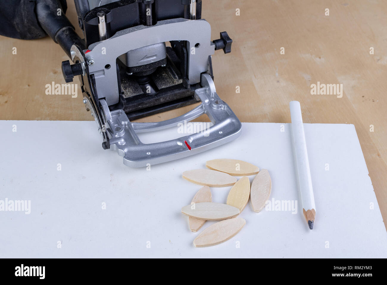 Joinery works in the workshop using sipes and a special milling machine. Light background. Stock Photo