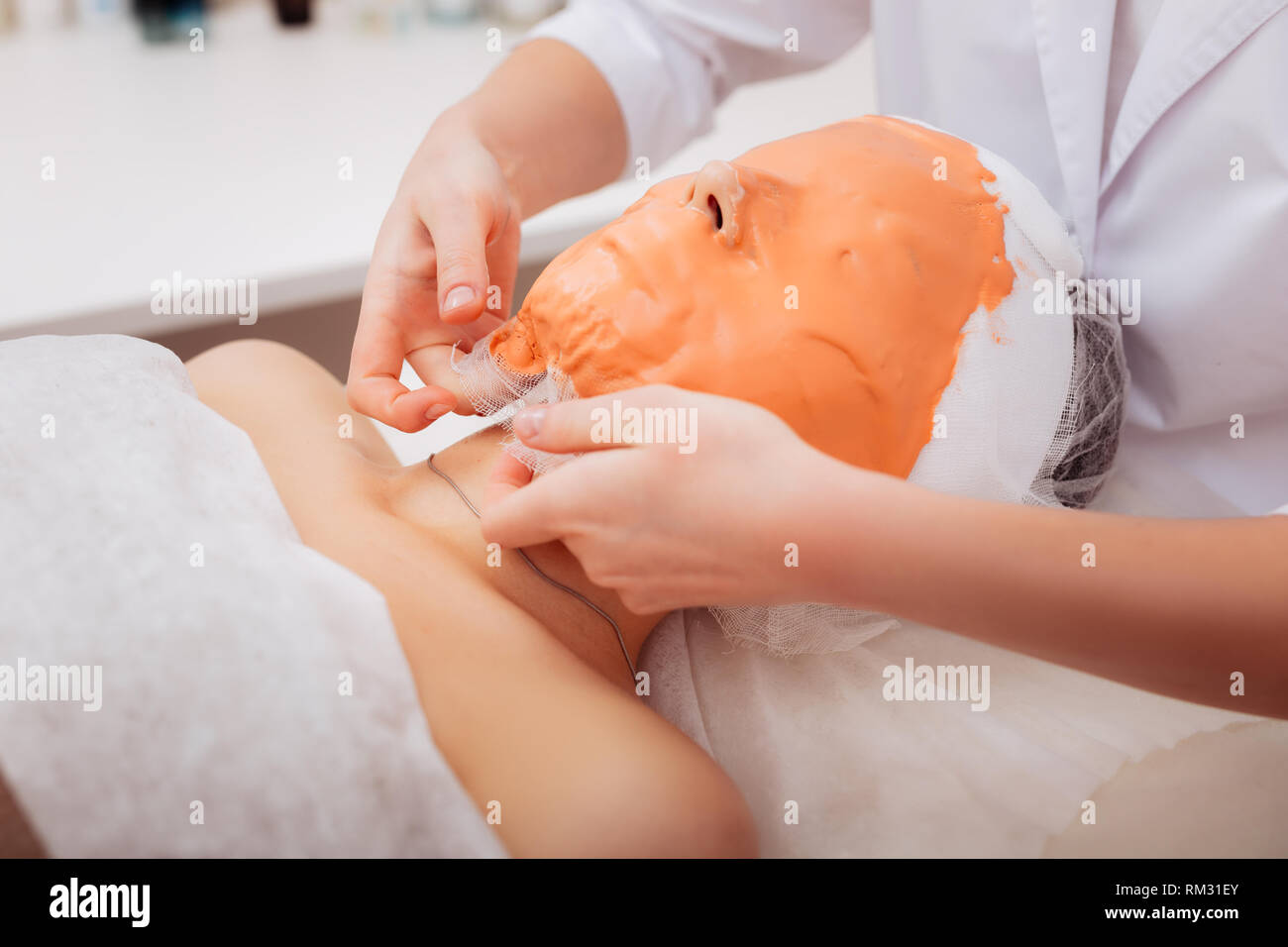 Nice skilled cosmetician taking off a mask Stock Photo