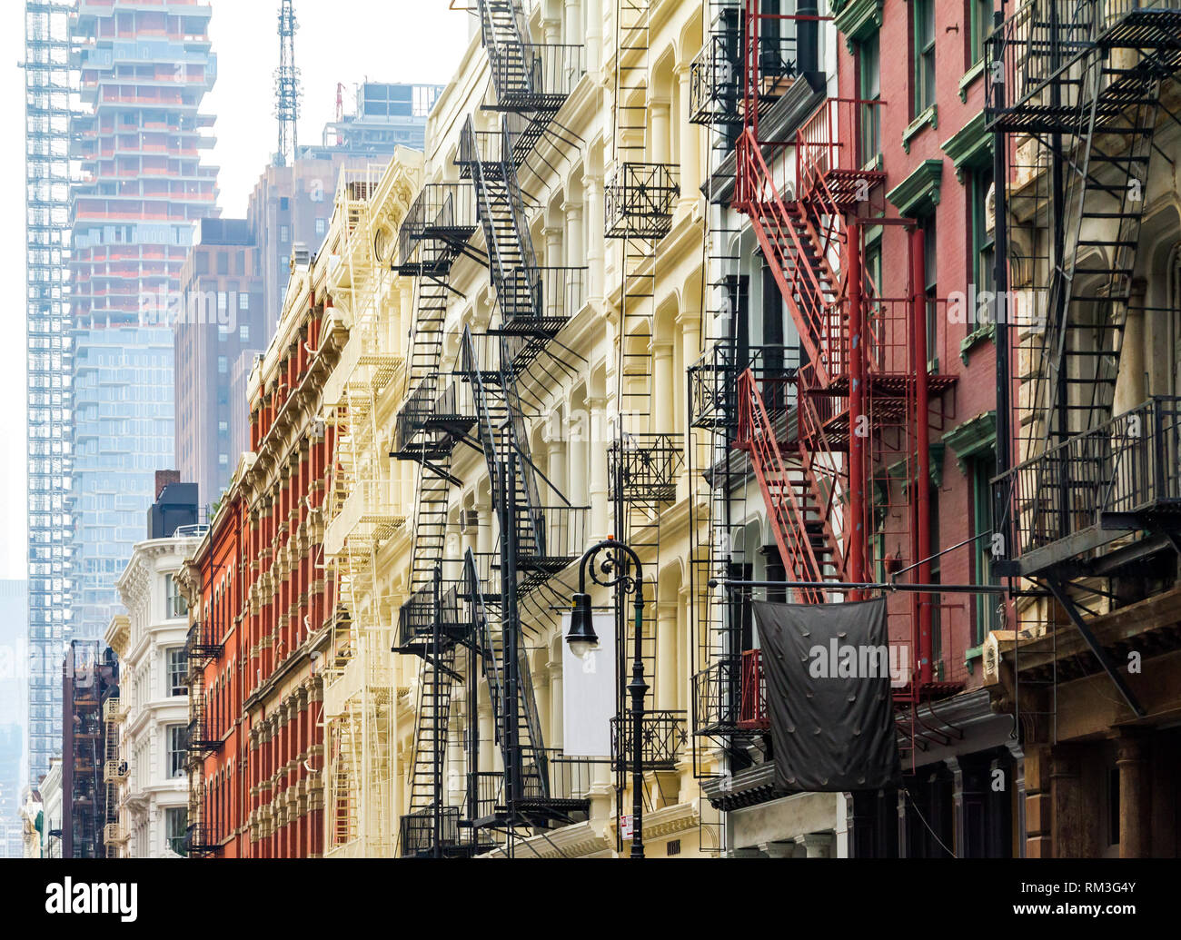 Old historic buildings along Greene Street in SoHo Manhattan contrast ...
