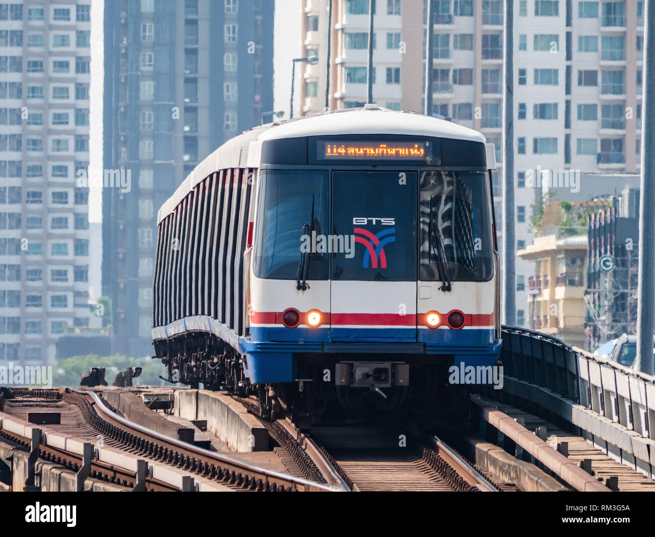 BTS Skytrain, the Silom Line, crossing the Chao Praya river at Saphan Taksin in Bangkok, with hi-rise condominiums in the background. Stock Photo