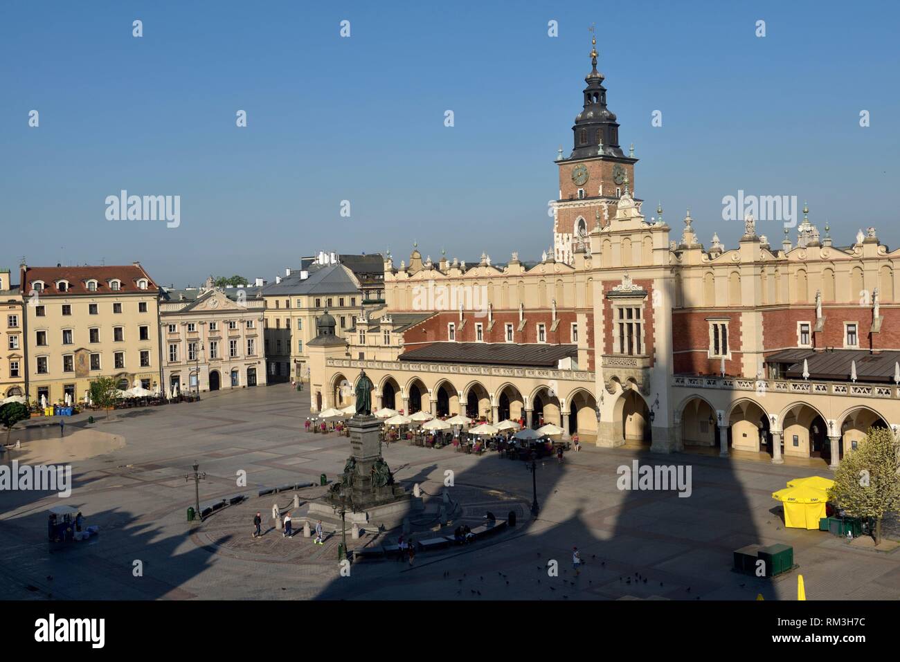 Adam Mickiewicz Monument, the Cloth Hall (Sukiennice) and Town Hall Tower on Rynek Glowny, the main square of the Old Town of Krakow, Malopolska Stock Photo