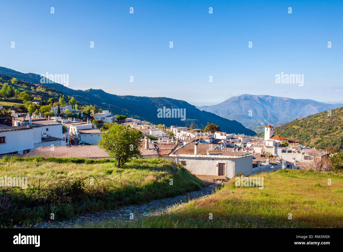 A view over Capileira, the highest and most northerly village in the Poqueira river gorge, in the Alpujarra region in the Sierra Nevada, Andalusia, Sp Stock Photo