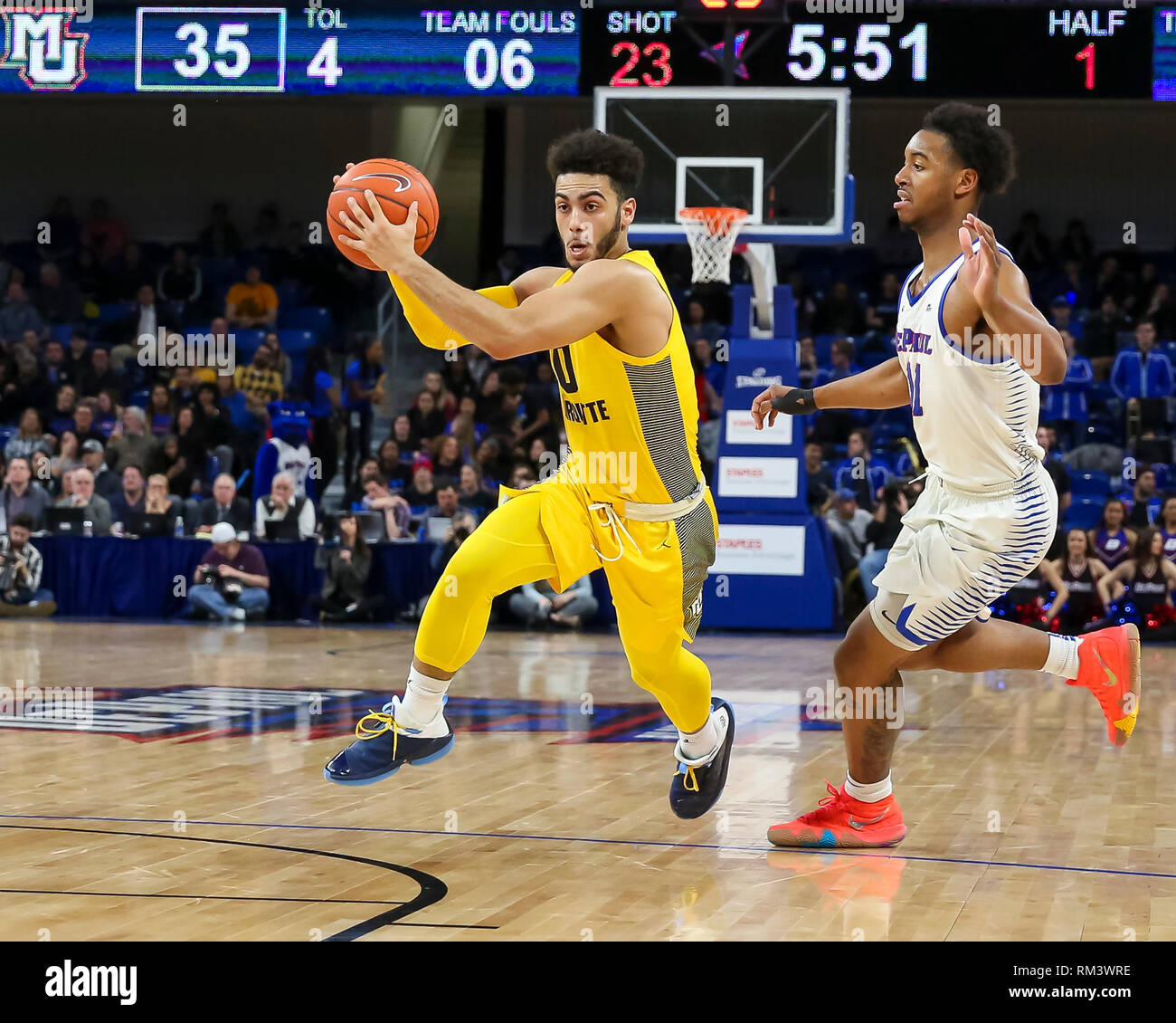Chicago, USA. 12th Feb 2019. Marquette Golden Eagles guard Markus Howard (0) drives from the top of the key past the defense of DePaul Blue Demons guard Eli Cain (11) during NCAA basketball game between the Marquette Golden Eagles and the DePaul University Blue Demons at Wintrust Arena in Chicago IL. Gary E. Duncan Sr/CSM Credit: Cal Sport Media/Alamy Live News Stock Photo