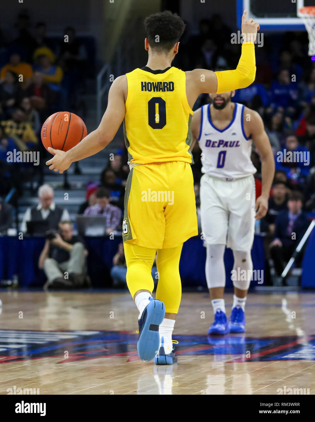 Chicago, USA. 12th Feb 2019. Marquette Golden Eagles guard Markus Howard (0) calls out a play while bringing the ball past halfcourt during NCAA basketball game between the Marquette Golden Eagles and the DePaul University Blue Demons at Wintrust Arena in Chicago IL. Gary E. Duncan Sr/CSM Credit: Cal Sport Media/Alamy Live News Stock Photo