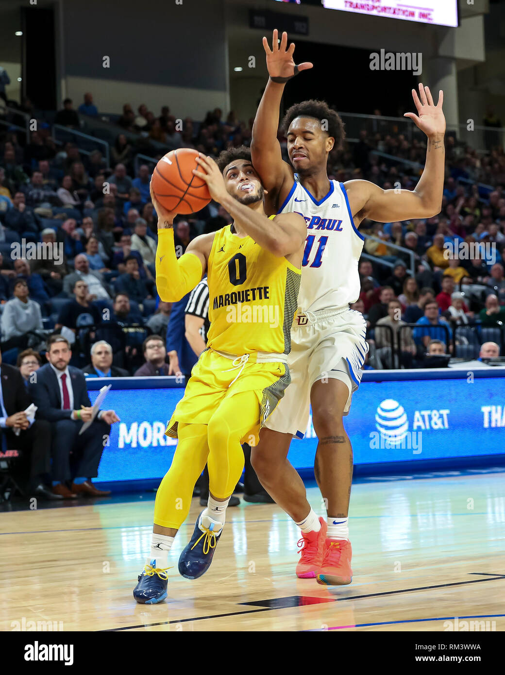 Chicago, USA. 12th Feb 2019. Marquette Golden Eagles guard Markus Howard (0) is fouled by DePaul Blue Demons guard Eli Cain (11) on a drive to the basket during NCAA basketball game between the Marquette Golden Eagles and the DePaul University Blue Demons at Wintrust Arena in Chicago IL. Gary E. Duncan Sr/CSM Credit: Cal Sport Media/Alamy Live News Stock Photo